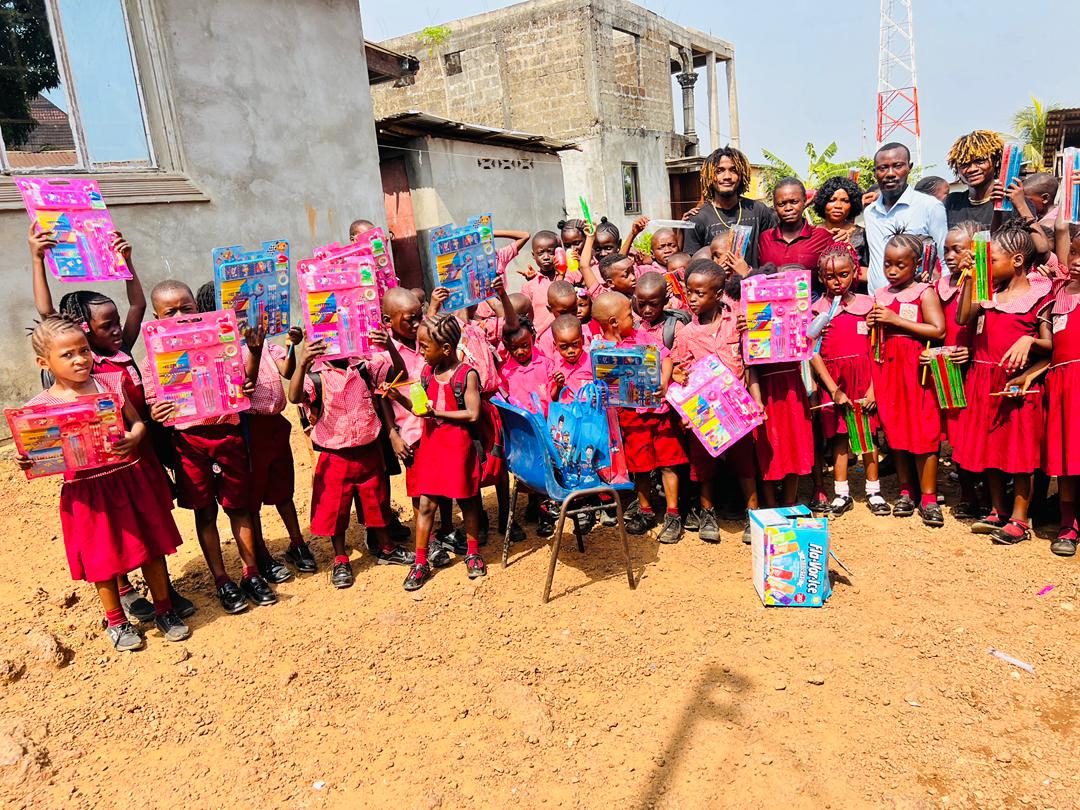 Golden Twins distributing school supplies to dozens of children in Freetown